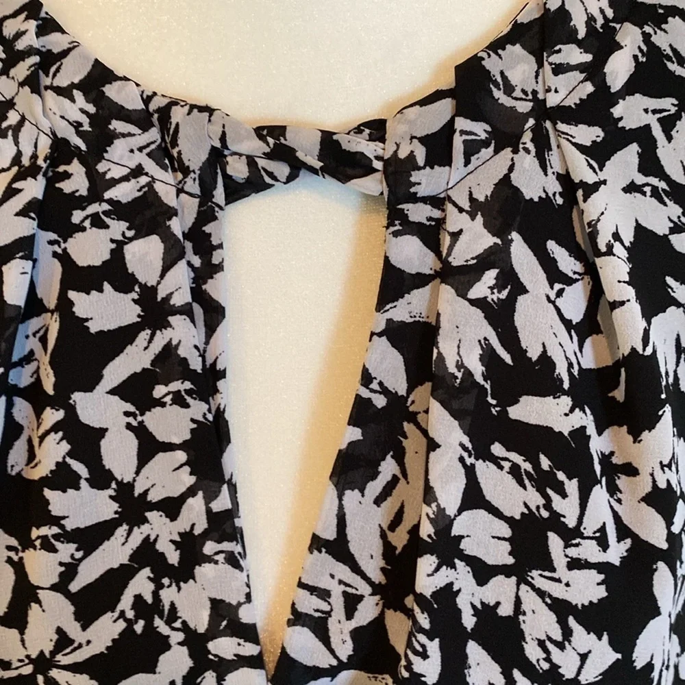 Karin Steven’s sleeveless black/white patterned lined dress. Tie at neck & waist